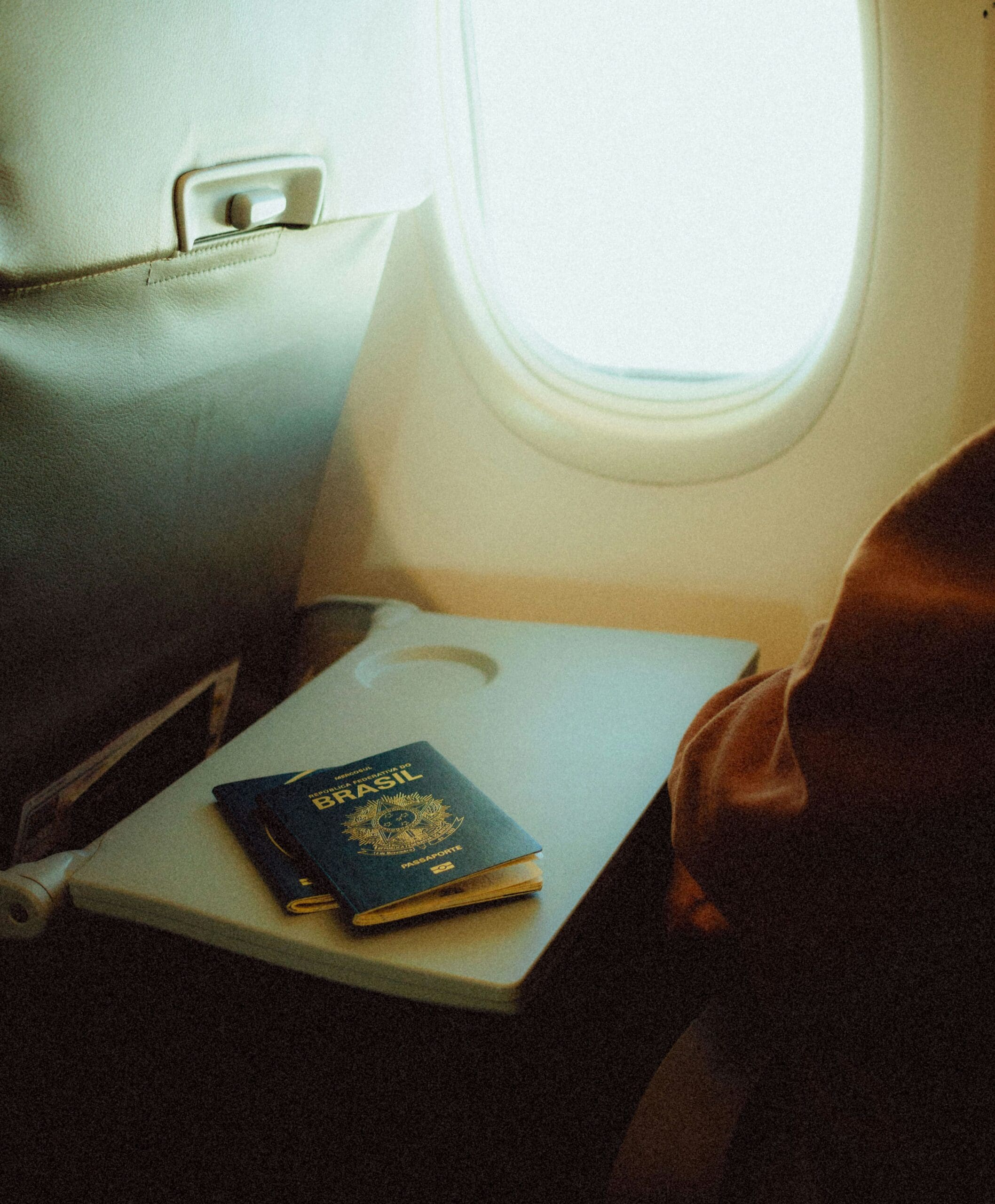 Passport on an airplane tray table symbolizing the journey of international MBA applicants pursuing study in the United States.