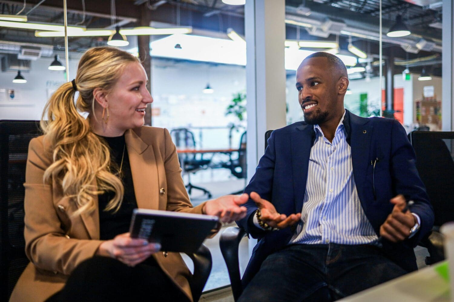 Early career professionals networking, reflecting the benefits of deferred MBA program community access.