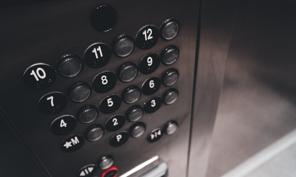 Elevator panel buttons symbolizing MBA elevator pitch strategy and interview communication tips.