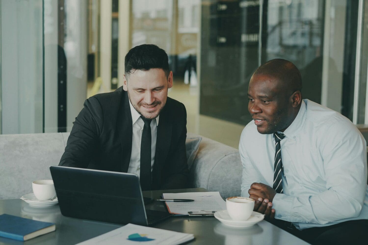 Two professionals reviewing MBA application strategy for military applicants.