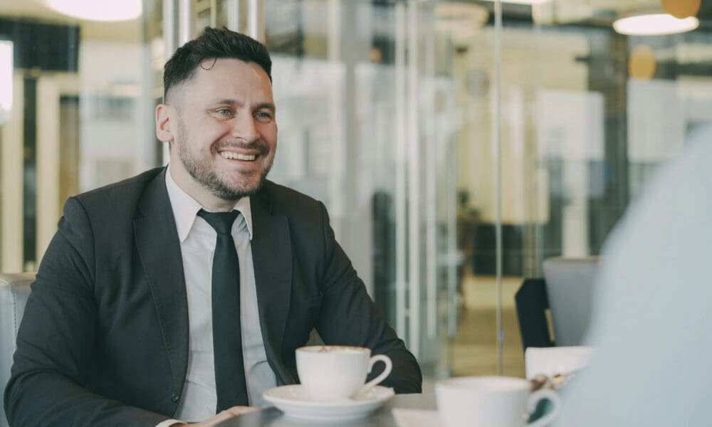 Professional MBA candidate in confident interview conversation at business school.