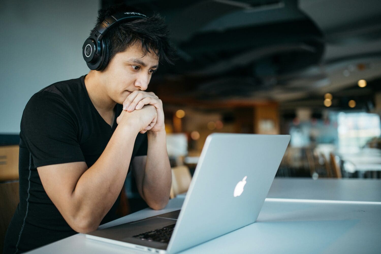 College senior studying at a desk, reflecting on future academic and career plans, including deferred MBA programs.